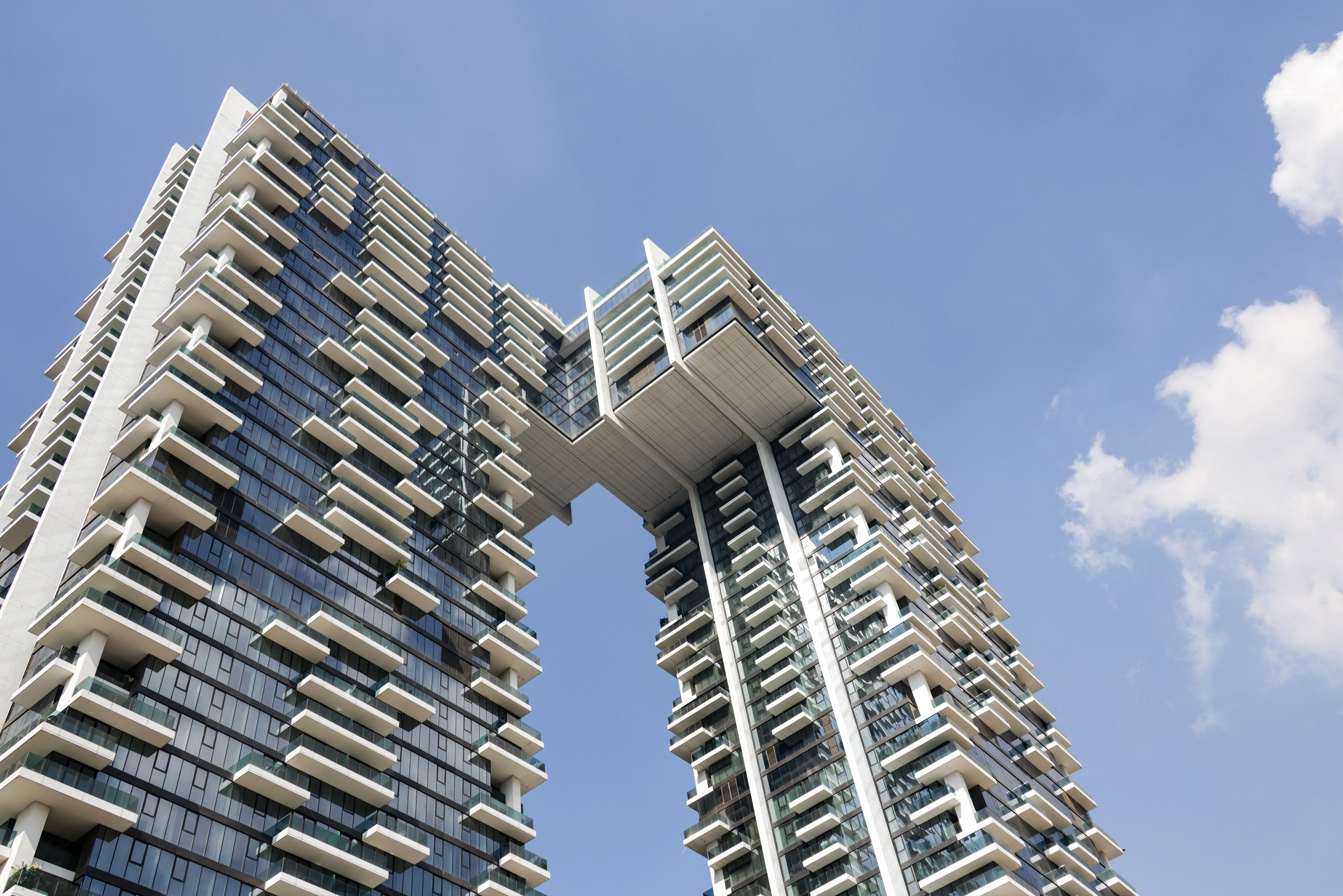 pexels-magda-ehlers-pexels-35142390 (1) Modern high-rise residential apartment building against a blue sky