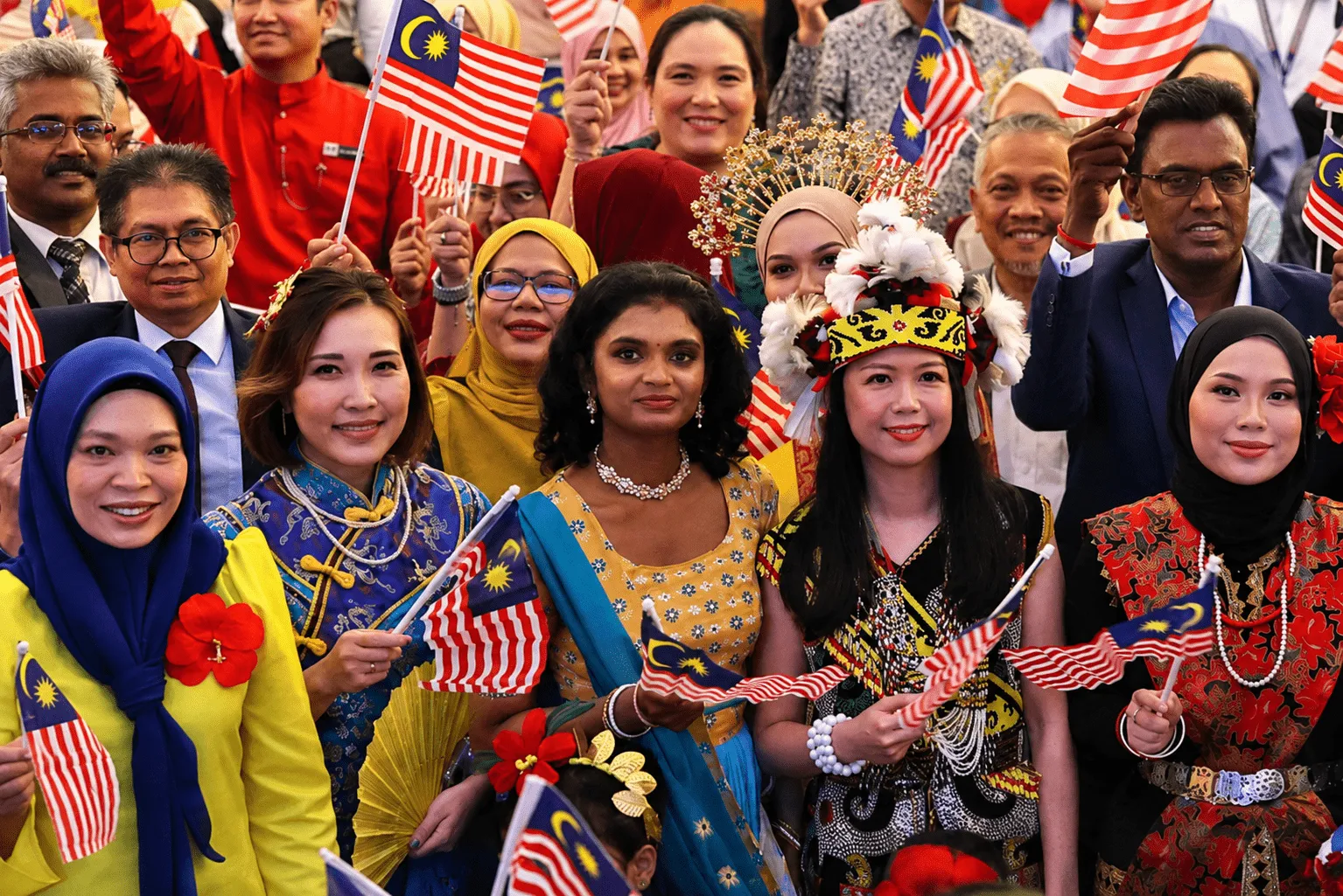 Celebrating Unity in Malaysia Group of diverse Malaysian people waving national flags and smiling